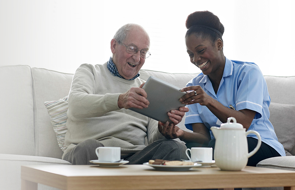 Nurse assists an elderly woman with skin care and hygiene measures at home